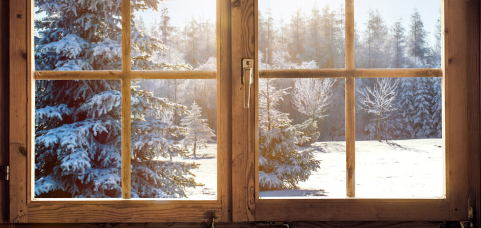 View,through,the,window,of,a,cottage,into,a,snow Covered