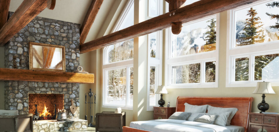 Luxurious,open,floor,cabin,interior,bedroom,design,with,roaring,fireplace